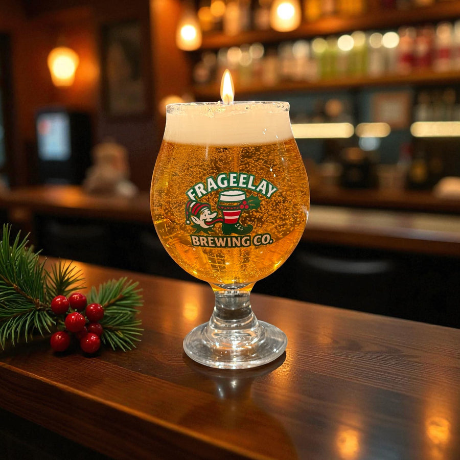 Glass of Frageelay Brewing Co. beer with a candle on a bar counter hand poured by CW Candle Co North Carolina 