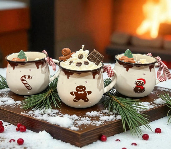 Whipped dessert candles in Christmas hot cocoa mugs topped with chocolate, candy, and holiday decor in front of a fireplace.