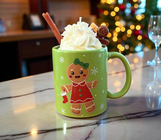 Green Holiday mug candle with whipped wax top, gingerbread figure, and Christmas tree backdrop Christmas Hearth scent by CW Candle Co.